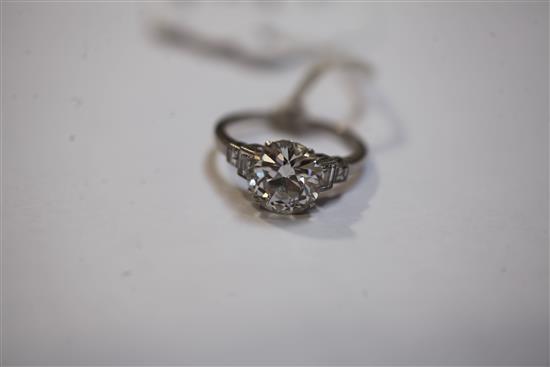 A mid 20th century single stone diamond ring, with graduated diamond set shoulders and diamond set setting, size N.